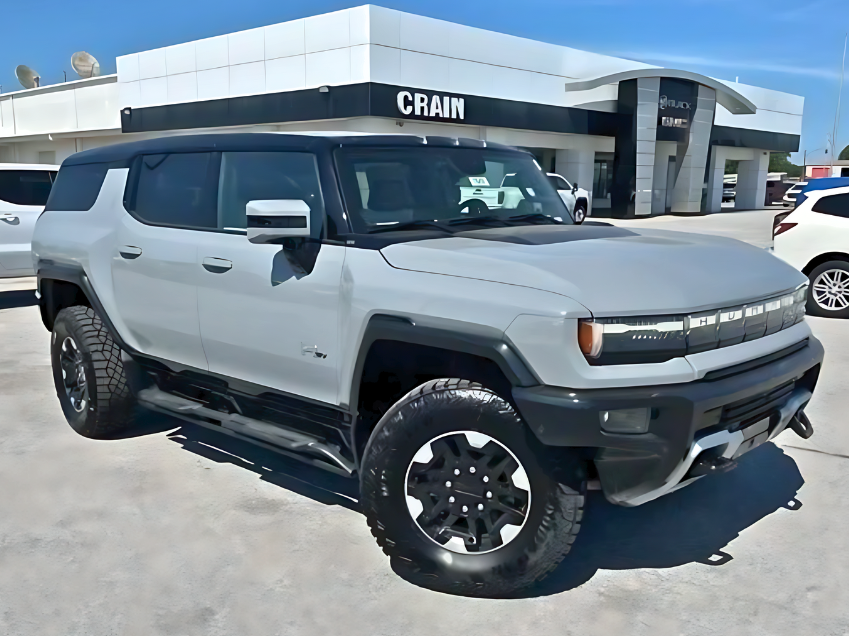 Light gray GMC Hummer EV SUV parked outside Crain Buick GMC dealership in Springdale, Arkansas